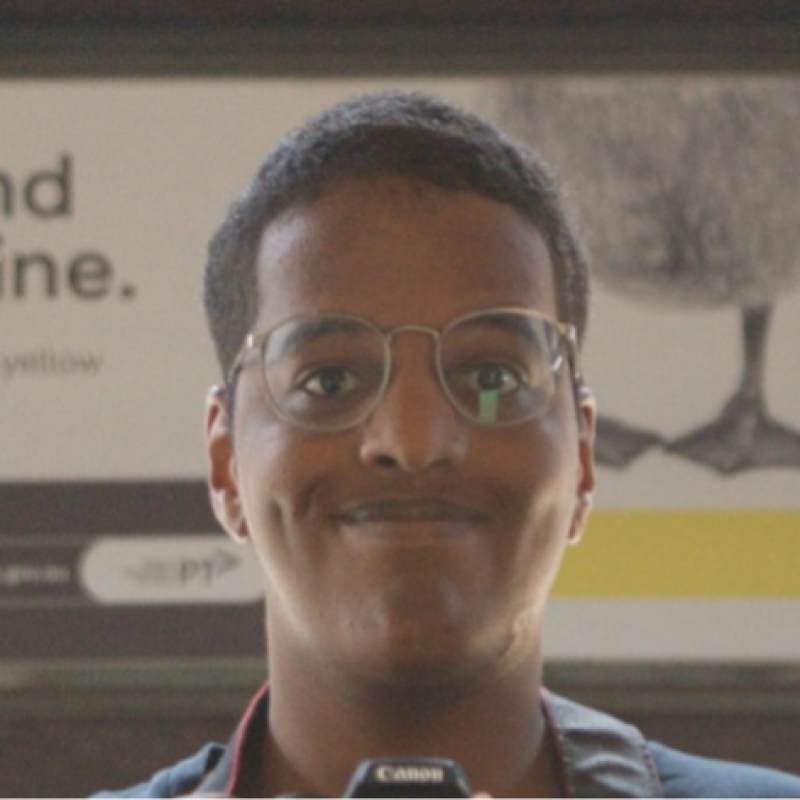 A self-portrait of me capturing myself in a train station mirror.